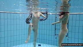 Shaved brunette with big tits underwater?