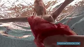 katya okuneva relaxes in red dress by the pool