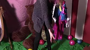 A European clown plays with balloons in an Italian setting.