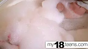 Cute redhead masturbates in bath, reaching intense orgasm closeup