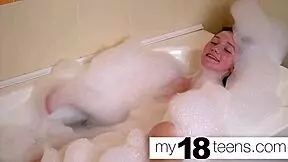 Cute redhead masturbates in bath, reaching intense orgasm closeup