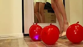 Petite brunette in heels crushes balloons with her feet, feeling the fetish thrill homemade
