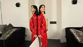 Young brunette in red latex exposes shaved pussy