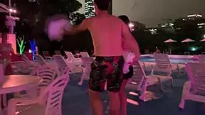 Night pool close-up on huge natural tits.