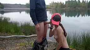 Brunette couple enjoys outdoor oral by the lake