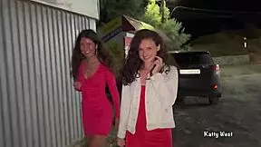 Girls pee next to car