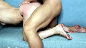 Fit couple enjoys homemade fun on sofa