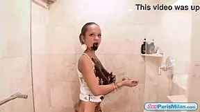 chocolate-covered teen paris milan slowly undresses in the shower, teasing with ripped clothes.