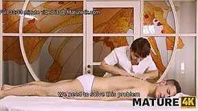 mature woman and client share fun in massage parlor setting