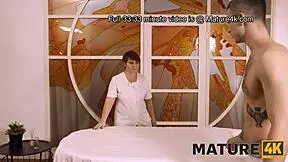 mature woman and client share fun in massage parlor setting