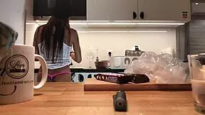 Why does the young wife flash her tight pussy while doing dishes?