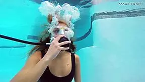 A perfect brunette babe Katya Nakolkina swims underwater in the pool