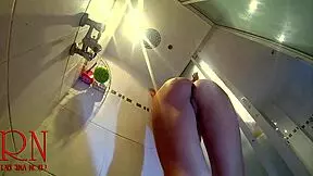 hidden camera catches a young naked girl stripping down in the shower room for a steamy view