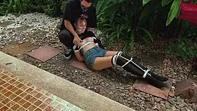 is this blonde beauty tangled in park bondage?