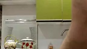 Raven-haired petite chick masturbates in the kitchen.