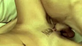 A young man deeply penetrates his pretty girlfriend from behind, filling her mouth with a large cumload