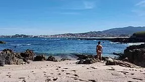 A curvy young woman enjoys nudism on the beach