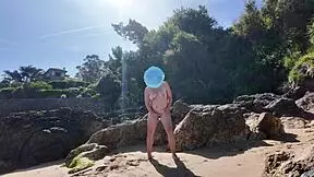 A curvy young woman enjoys nudism on the beach