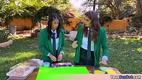 cute teen in uniforms sets up free stand at university event