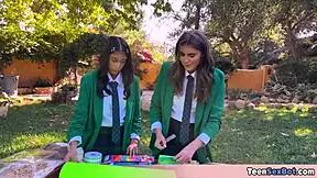 cute teen in uniforms sets up free stand at university event