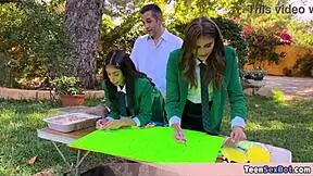 cute teen in uniforms sets up free stand at university event