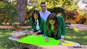 cute teen in uniforms sets up free stand at university event