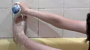 Look at this naked girl bathing with soapy foam all over her body