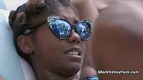 nubian princess expertly sucks a thick white cock by the pool under the hot sun.