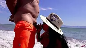 Mature couple enjoys risky outdoor activity at public beach during Mexico holiday