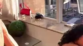 Couple enjoys intimate moment in building window for neighbors