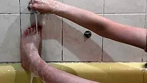 beautiful naked girl assol bathes with soapy foam on wet pussy natural tits