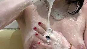 beautiful naked girl assol bathes with soapy foam on wet pussy natural tits