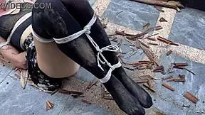 hottie in stockings tied and tickled outdoors