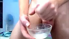 The hung shemale jerks off and squirts a big load into the bowl.