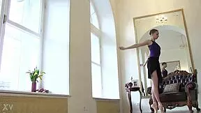 Sensual teen ballerina Annett A lies nude on the wooden floor, showcasing her shaved pussy and natural tits beautifully