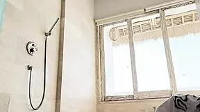 Beautiful young girl washes clothes in the shower while traveling