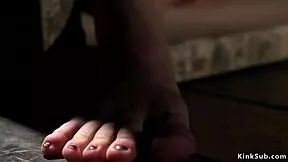 Master straps petite slave in wooden box for kinky whipping.