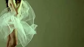 A blonde gymnast showcases her flexibility and athleticism during a gymnastics routine.