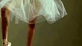 A blonde gymnast showcases her flexibility and athleticism during a gymnastics routine.