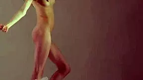 A blonde gymnast showcases her flexibility and athleticism during a gymnastics routine.