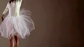 A blonde gymnast showcases her flexibility and athleticism during a gymnastics routine.