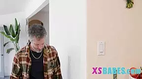 A cute petite teen 18+ enjoys a lighthearted game with friends.