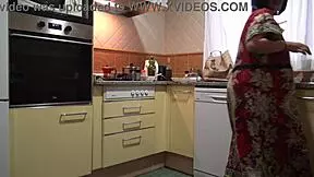 Stepmom chats with stepson in the kitchen about daily routines