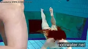 Milana and Katrin tease each other by ripping bikinis off in the pool. They swim nude underwater in softcore fun.