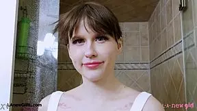 This fresh-faced blonde teen steps into the shower solo, letting water cascade over her petite body.