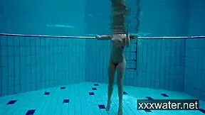 Milana and Katrin tease each other by ripping bikinis off in the pool. They swim nude underwater in softcore fun.