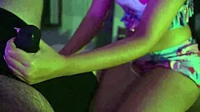 Cute petite girl gives handjob over underwear.