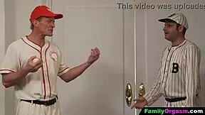 Girls playfully interact with baseball player fathers