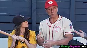 Girls playfully interact with baseball player fathers