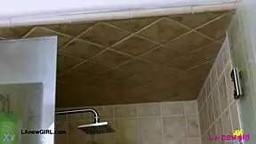 Stunning bronze model enjoys a relaxing shower during photoshoot